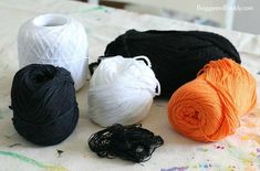 three skeins of yarn sitting on top of a table