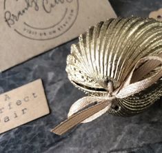 a close up of a metal object on a table near some business cards and tags