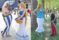 two women dressed in costumes standing next to each other on the sidewalk and one woman holding a basket