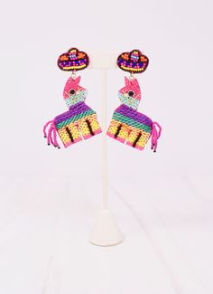 This party piñata earring is so bright and colorful! It is embellished with sequins and has a beaded sombrero. Dimensions: 3" long Multicolor Novelty Earrings, Adjustable Fun Party Earrings, Whimsical Multicolor Festival Earrings, Playful Summer Party Jewelry, Party Earrings With Colorful Beads, Summer Party Beaded Dangle Earrings, Party Colorful Beaded Earrings, Handmade Rainbow Beaded Earrings For Party, Dangle Beaded Earrings For Summer Parties