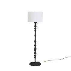 a floor lamp with a white shade on the base and a cord attached to it