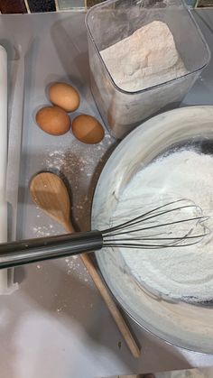 flour and eggs are being whisked in a bowl