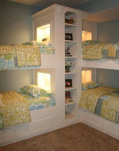 there are three bunk beds with lights on the top and bottom shelves in this room