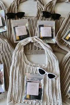 six bags with sunglasses on them sitting next to each other and one bag in the middle