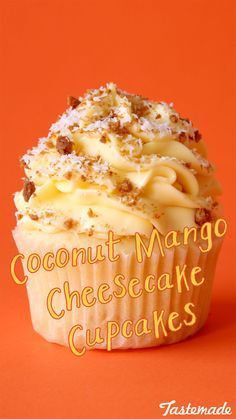 a cupcake with coconut mango cheesecake toppings on an orange background that reads, coconut mango cheesecake cupcakes