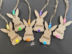 four wooden easter bunnies with name tags on them