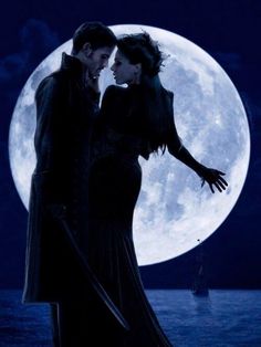 a man and woman standing next to each other in front of a full moon