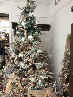 a decorated christmas tree with gold and silver ornaments