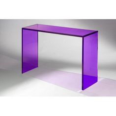 a purple glass table sitting on top of a white floor