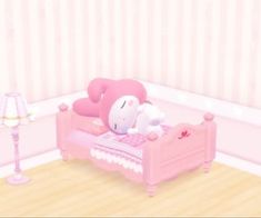 a pink bed with a stuffed animal sitting on it's side in a room