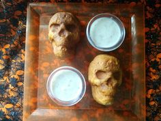 three pastries on a glass plate with dips