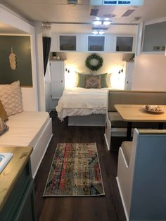 a small bedroom with a bed, couch and table in it's center area