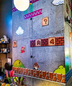 the wall is decorated with video games and mario's house decorations on it, along with other items