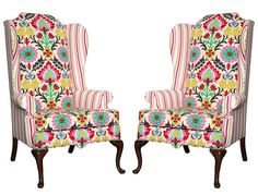 a pair of chairs with floral designs on them