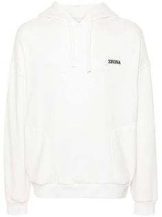 white cotton blend jersey texture drawstring hood embroidered logo at the chest two side inset pockets drop shoulder long sleeves ribbed cuffs and hem Athleisure Hoodie Sweatshirt With Logo Detail, Oversized Hoodie Sweatshirt With Logo Detail, Oversized Long Sleeve Hoodie With Logo, Sporty Hoodie With Embroidered Logo For Spring, Sporty Hoodie With Logo Detail, Oversized Cotton Hoodie With Logo Detail, Sporty Hoodie Top With Logo Detail, Sporty Hoodie Top With Logo, White Embroidered Logo Sweatshirt For Loungewear