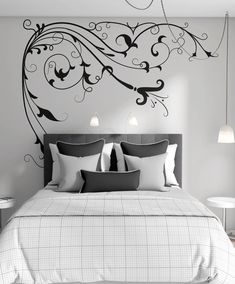 a bedroom with a large bed and wall decal