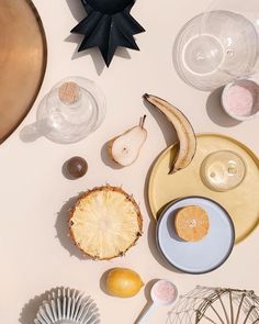 an assortment of food items displayed on a table with utensils and spoons