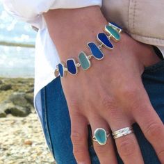 "CURRENTLY OUT OF STOCK IN SKY, BLUES and PASTEL - Please send us a message if you would like to be notified when these color combinations are back in stock! This elegant bracelet wonderfully showcases a selection of 9 pieces of authentic beach found sea glass each custom bezel set in sterling silver. Each piece of sea glass has been carefully preserved in sterling silver with an open back design to allow the light to shine through and highlight the gorgeous colors of the piece. The bracelet is Simple Leather Bracelet, Seaglass Jewelry, Beach Glass Necklace, Sea Necklace, Sea Glass Bracelet, Surfer Necklace, Beachglass Jewelry, Beach Necklaces, Toggle Bracelet