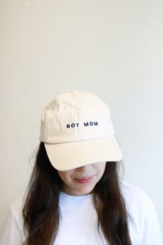 Being a Boy Mom becomes your identity, so we made a hat that celebrates it! The unisex fit is embroidered with Boy Mom on the front and has an adjustable strap in the back. Here are the details: - Adjustable strap designed to fit most - made of a soft, flexible cotton twill - Color: White, navy thread- design is exclusive to polished prints Adjustable Trucker Hat With Embroidered Logo And Visor, Adjustable Cotton Snapback Hat With Embroidered Logo, Embroidered Logo Adjustable Cotton Snapback Hat, Embroidered Snapback Visor Hat, Adjustable Letter Print Cap, Adjustable Visor Fitted Hat With Embroidered Logo, Adjustable Visor With Embroidered Logo, Adjustable Fitted Visor With Embroidered Logo, Adjustable Cotton Fitted Cap