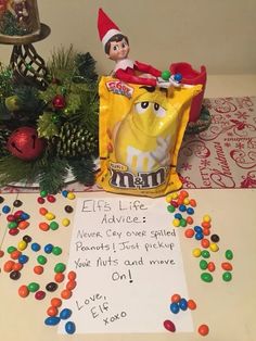 an elf's life advice next to a bag of m & m candy