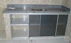 a kitchen counter with glass doors and tile on the wall next to it is being remodeled