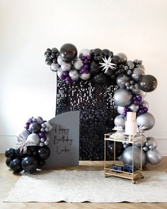 a black and silver birthday party with balloons