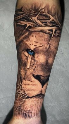 a man's leg with a lion and cross tattoo on it