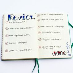 an open notebook with writing on it and some green string attached to the book's cover