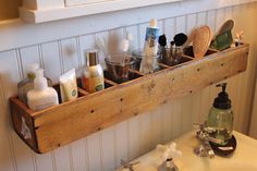 a wooden shelf filled with personal care items on top of a white sink in a bathroom