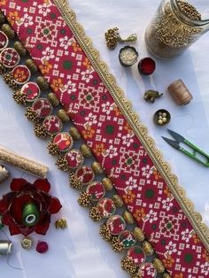 a table topped with lots of different types of beads and other things on top of it