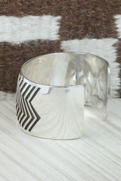 This sterling silver bracelet was made by Navajo silversmith Freddie Douglas. The inside is signed and stamped sterling.Size: 5 1/2" (will fit up to a 6 5/8" wrist)Gap: 1 1/8"Width: 1 3/8"Free shipping on all orders! We ship with USPS and always include tracking. All orders ship within a day of payment.Returns are accepted up to 30 days after you receive your order. Just send us a message. Our shop offers cash back or store credit. The item must be returned in new condition. Southwestern Silver Cuff Bracelet With Inlay, Artisan Silver Cuff Bracelet With Inlay, Silver Inlay Cuff Bracelet Bangle, Sterling Silver Inlay Bracelets In Silver Color, Unique Sterling Silver Cuff Bracelet With Inlay, Sterling Silver Bracelet, Native American Jewelry, Free Jewelry, Sterling Silver Bracelets