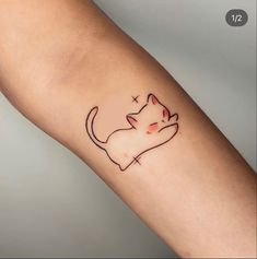 a small cat tattoo on the arm