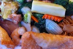 a close up of food on a plate with broccoli and other foods in it