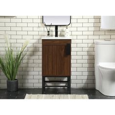 a white toilet sitting next to a wooden cabinet with a mirror on top of it