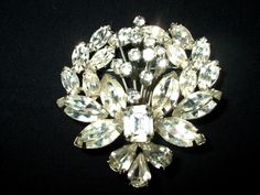 Vintage hard to find Weiss large rhinestone brooch is in very good vintage condition. No scratches or oxidation. One emerald cut, lots of marquise and teardrop, and tiny round stones in the center "bouquet". NO missing stones. The clasp works fine. There are some stones that have a slight tint of yellow. I have not attempted to clean this item. Measures about 1.75 inch by 2 inches. If you need more photos let me know. I am not a vintage jewelry expert so just check out the pictures.I have other vintage jewelry and Christmas jewelry in the store. All of it ships priority so you can save on shipping if you would like more than one item. Just click on my jewelry section over there to the left, or  click this: www.etsy.com/shop/badkittyvintagefinds?section_id=14398871&ref=shopsection_leftnav_7 Brooch Styling, Costume Jewelery, Vintage Jewelry Antique, Antique Costume Jewelry, Jewelry Antique, Vintage Gothic, White Rhinestone, Rhinestone Brooches, Christmas Jewelry