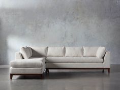 a white couch sitting next to a gray wall