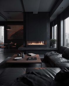 a living room filled with black furniture and a fire place in the middle of it