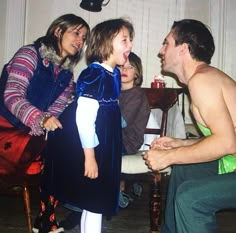 a group of people sitting around each other in front of a man and woman talking to one another