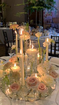 a table with candles and flowers on it