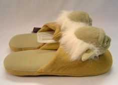 a pair of slippers with fuzzy feet and white fur on the bottom are shown