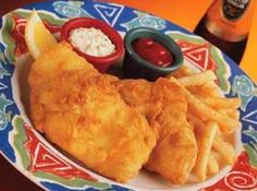 fish and chips on a plate with ketchup