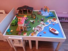 a play table with toys on it in a child's room or playroom