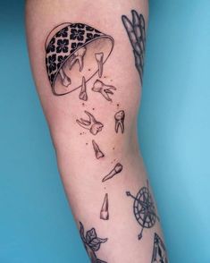 a tattoo on the leg of a person with many objects coming out of her body