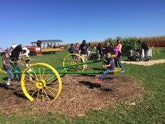 children playing with an old fashioned farm equipment