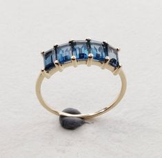 **KINDLY CHECK OUT THE VIDEO OF THE ITEM FOR A CLEARER VIEW**The video of this product is available on: https://www.instagram.com/p/B1zAmKmn1l6/?igshid=18p8ycu3i3f6q Details of the ring Gemstone: Center Gem: London blue topaz gem shape,size & weight: baguette , 5×3 mm ( 5pc ) & 2.05 carats Metal: GOLD Purity: 14 KT Weight: 1.24 Grams Total weight of the ring: 1.64 grams Beautiful emerald cut london blue topaz rich deep blue color set in 14kt , a perfect gift for a woman. The Gold purity Blue Topaz Baguette Cut Ring In 14k Gold, 14k Gold Multi-stone Topaz Ring, Gold Blue Topaz Multi-stone Ring, Elegant Multi-stone Topaz Ring In 14k Gold, Blue Emerald-cut Topaz Ring In 14k Gold, Blue Topaz Multi-stone Ring In 14k Gold, Handmade Jewelry Box, London Blue Topaz Ring, Black Onyx Ring