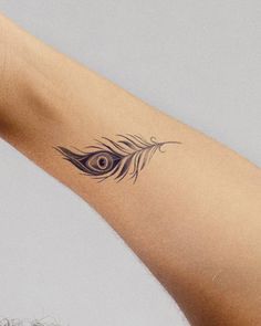 a woman's arm with a tattoo on it that has an eye in the middle