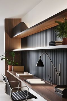 an office with wooden shelves and desks, bookshelves, plants and lamp