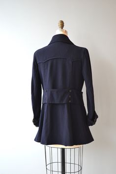 "Antique 1910s Edwardian jacket in deep navy blue gabardine wool with high buttoning scalloped collar, wide button front back repeated at the back, wide cuffed sleeves and double venting. Unlined (lining has been removed). --- M E A S U R E M E N T S --- fits like: medium shoulder: 16\" bust: 34-38\" waist: 34\" sleeve: 21\" length: 29\" brand/maker: n/a condition: excellent ★ layaway is available for this item ➸ More vintage coats http://www.etsy.com/shop/DearGolden?section_id=5800175 ➸ Visit t Edwardian Coat, Edwardian Jacket Women, Edwardian Winter Coat, Vintage Double-breasted Pea Coat With Double Button Closure, Vintage Double-breasted Wool Coat, Cuff Sleeves, Wool Jacket, High Neck Dress, Jackets & Coats