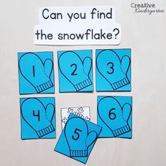 blue paper cutouts with numbers and mittens on them to spell out the snowflake