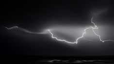 a black and white photo of lightning in the sky